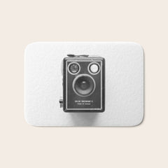 A Kodak Brownie analog vintage camera on a white background Retro photography in black and white Bath Mat
