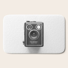 A Kodak Brownie analog vintage camera on a white background Retro photography in black and white Bath Mat