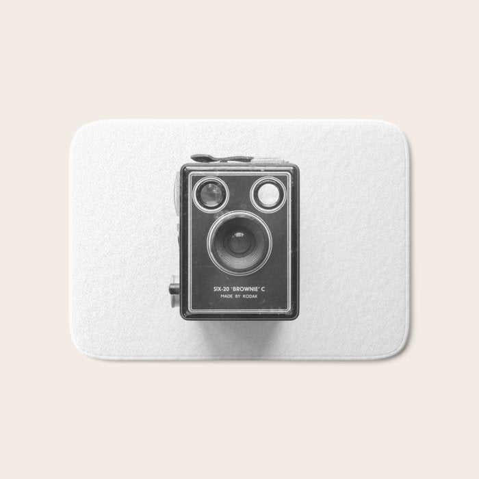 A Kodak Brownie analog vintage camera on a white background  Retro photography in black and white Bath Mat