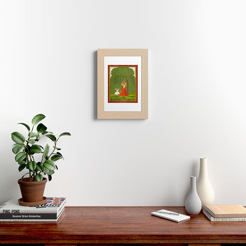 A female attendant is standing in tribhanga pose under a tree. A small child vies for her attention. Framed Art Print